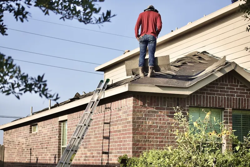 Professional roofer working on a residential roof in North Windham
